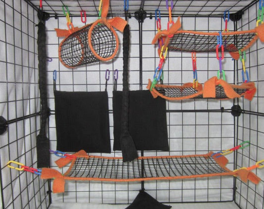 11-piece neon orange mesh sugar glider cage set featuring breathable hammocks, tunnel, bridge, fleece pouches, braided ropes, and assorted C-links arranged inside a display cage for small pet comfort and enrichment.