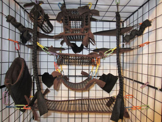 15-piece brown mesh sugar glider cage set displayed in an enclosure, featuring cube pouches, hammocks, and breathable accessories for small pet comfort.