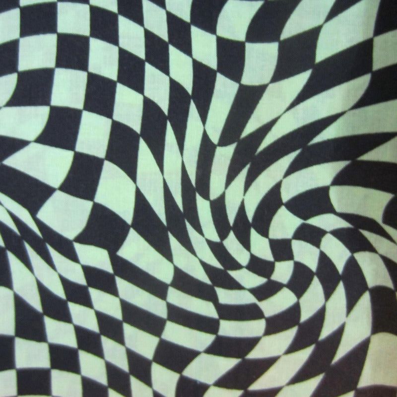 Close-up of green checkered flag fleece fabric used in sugar glider cage accessories.