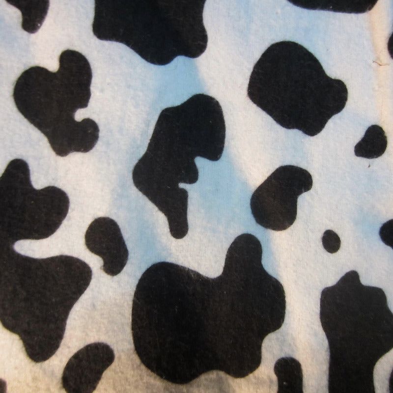 Close-up of cow print fabric, ideal for sugar glider cage accessories.