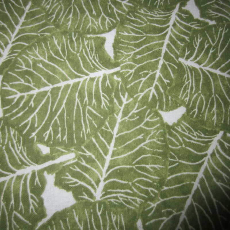 Close-up of green leaf-patterned fabric used in sugar glider cage accessories.