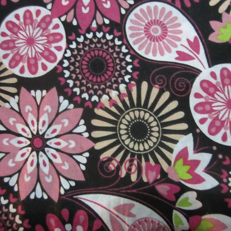 Close-up of fabric featuring pinwheel and flower patterns, used in sugar glider cage accessories.