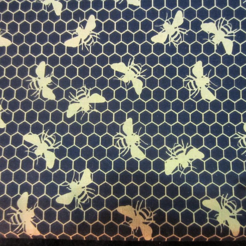 Close-up of honey and bees-themed fabric used in sugar glider cage accessories.