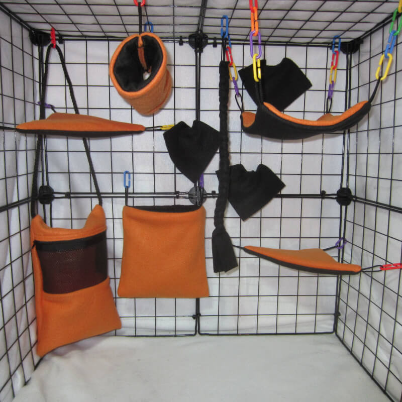 10pc Neon Orange fleece sugar glider cage set with Bonding Pouch, standard pouch, hammock, and accessories for a bright themed glider habitat.