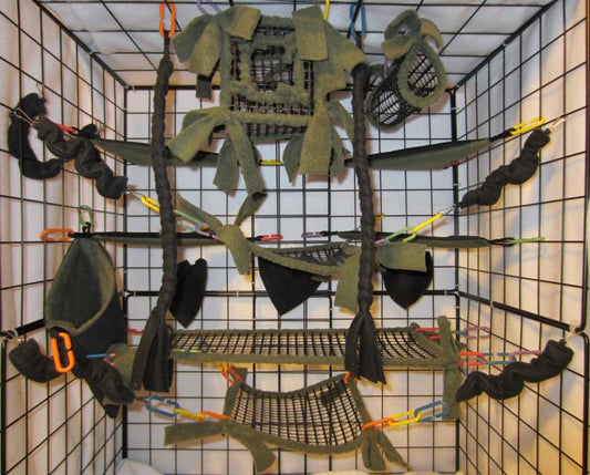 15-piece forest green mesh sugar glider cage set displayed inside a metal enclosure, featuring breathable cube hideouts, hammocks, tunnels, and accessories designed for small pet comfort and enrichment.