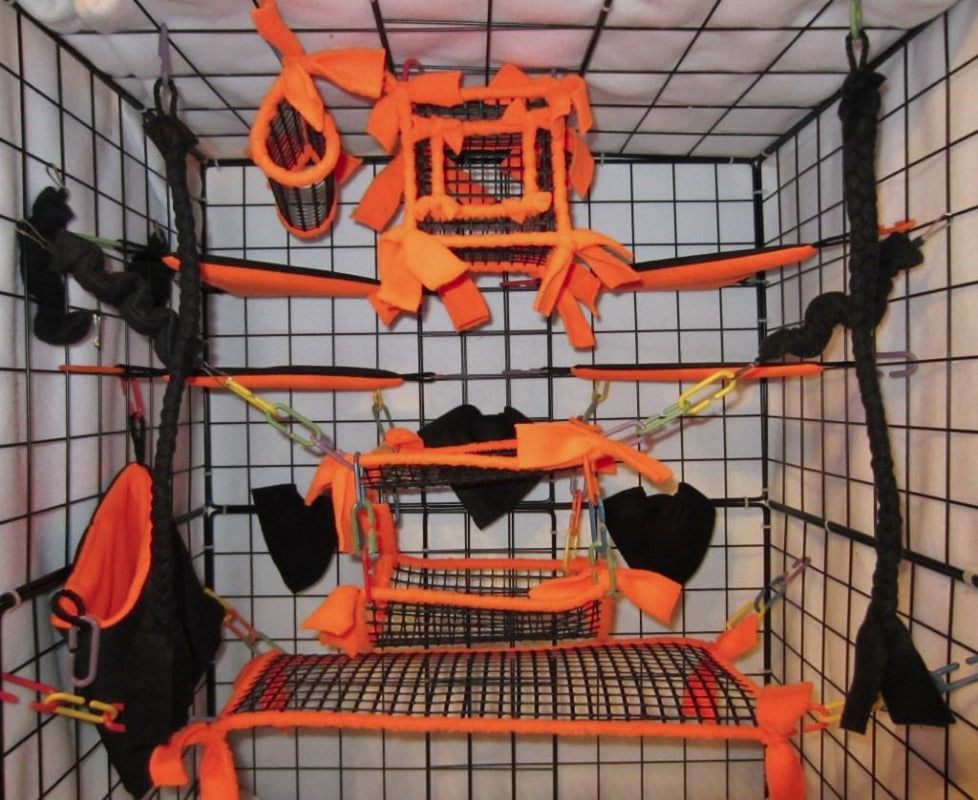15-piece neon orange mesh sugar glider cage set displayed inside a metal cage, featuring breathable cube-shaped pouches, tunnels, and hanging beds for small pet comfort and enrichment.