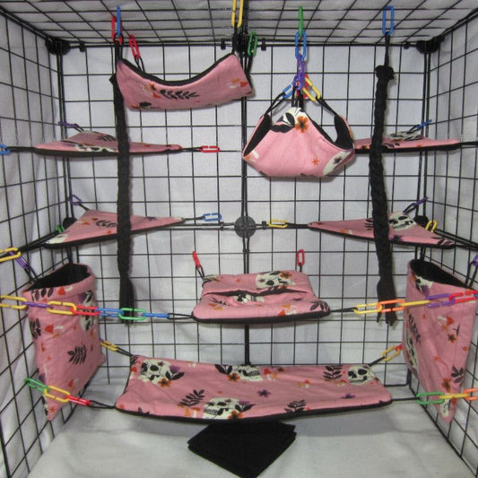 17-piece pink skulls fleece sugar glider cage set with hammocks, pouches, and cozy accessories for your glider's comfort.