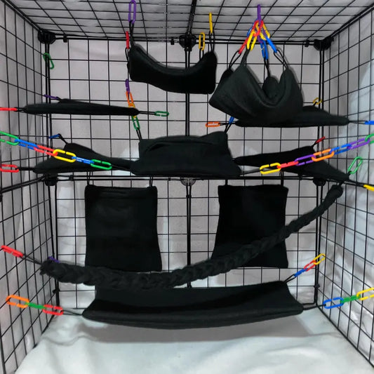 Black sugar glider fleece cage set with hammocks, pouches, shelves, and braided rope installed in a wire cage.