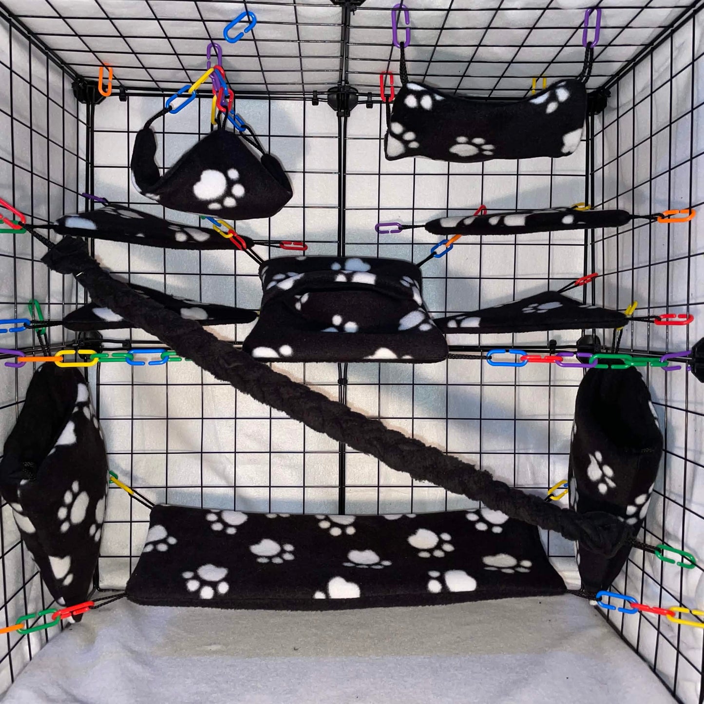 Black paw print sugar glider cage set with hammocks, pouches, bridges, and fleece vine. Handmade cage accessories for pet gliders.