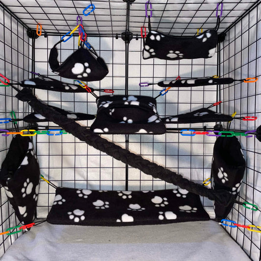 Black paw print sugar glider cage set with hammocks, pouches, bridges, and fleece vine. Handmade cage accessories for pet gliders.