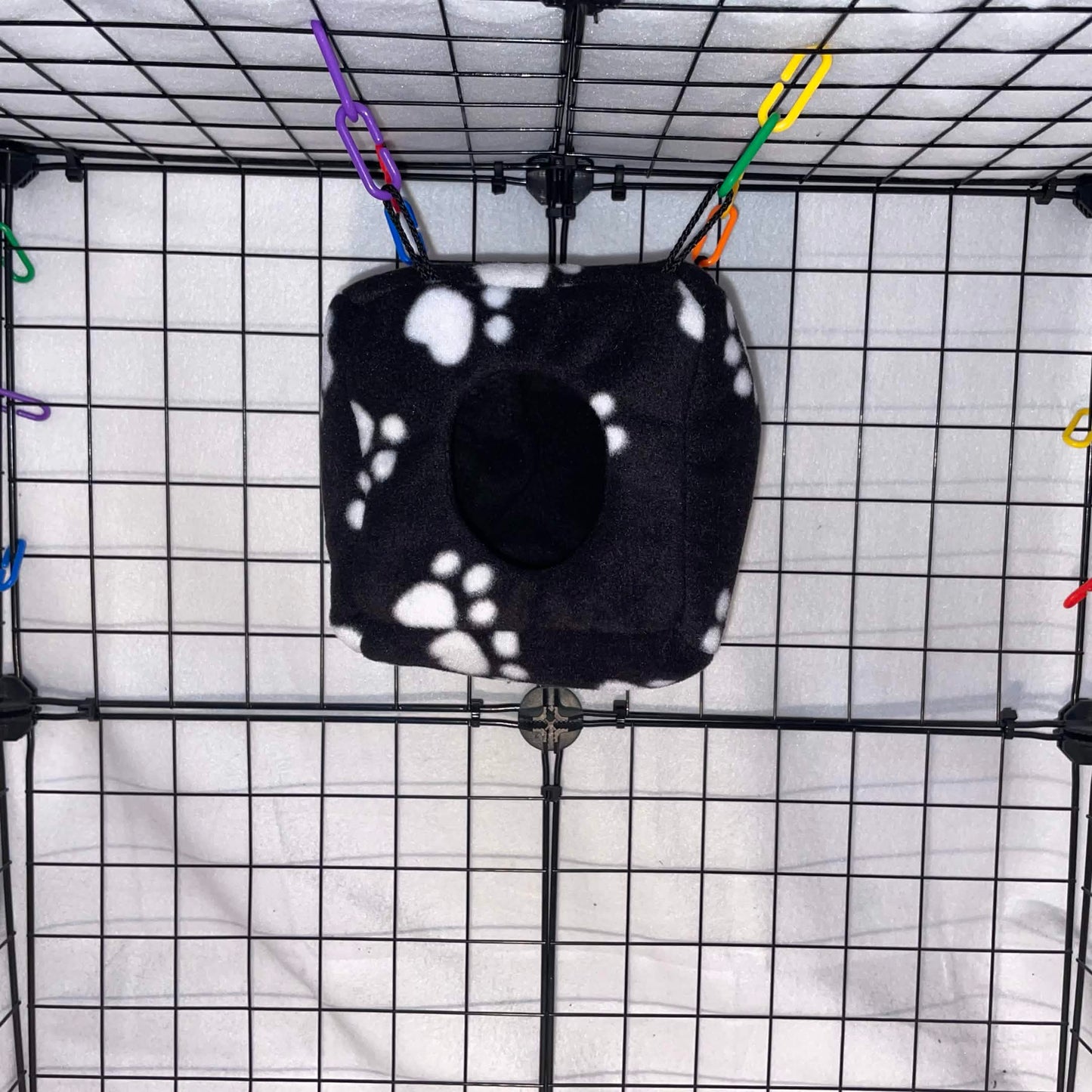 Black paw print sugar glider cube hideout made with soft fleece for cozy sleeping, climbing, and cage enrichment. Handmade in the USA.