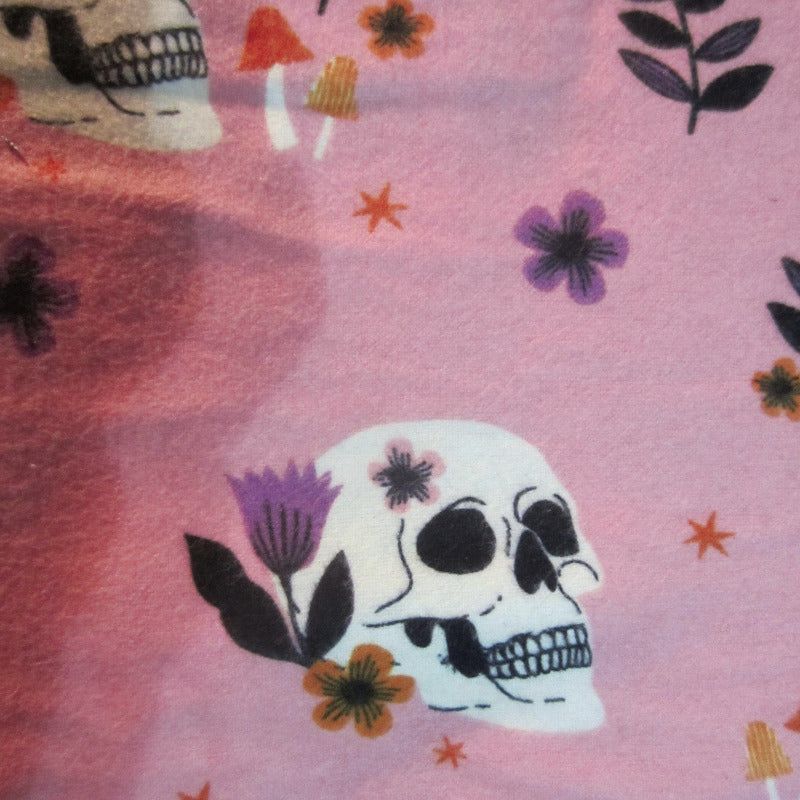 Close-up of pink skulls fabric, designed for sugar glider cage accessories.