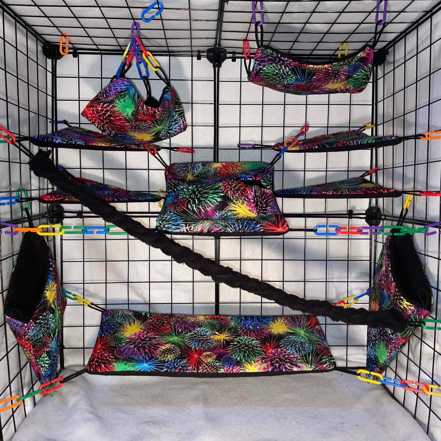 Firework print sugar glider cage set with hammocks, pouches, bridges, shelf liners, and fleece vine. Handmade cage accessories for pet gliders.