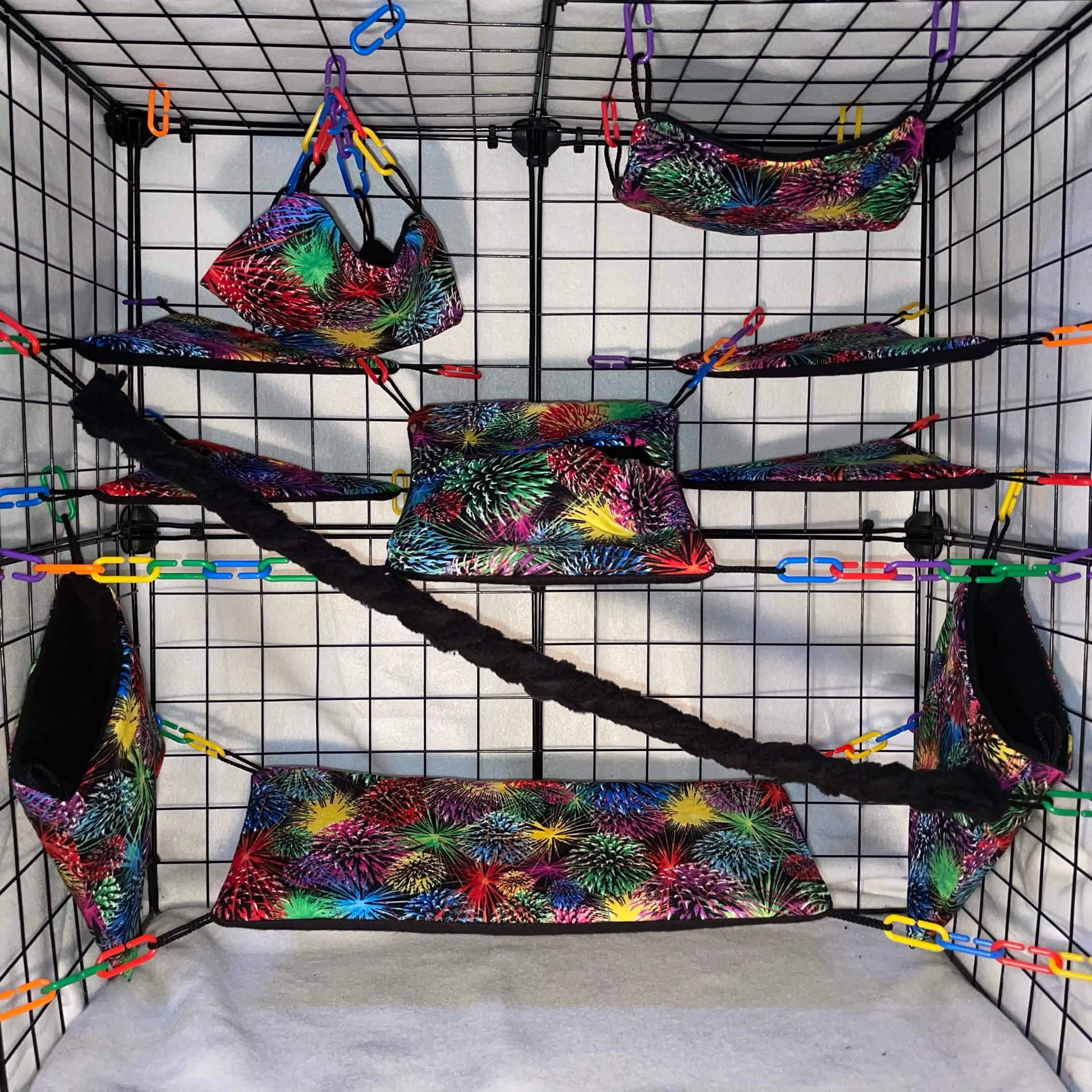 Firework print sugar glider cage set with hammocks, pouches, bridges, shelf liners, and fleece vine. Handmade cage accessories for pet gliders.