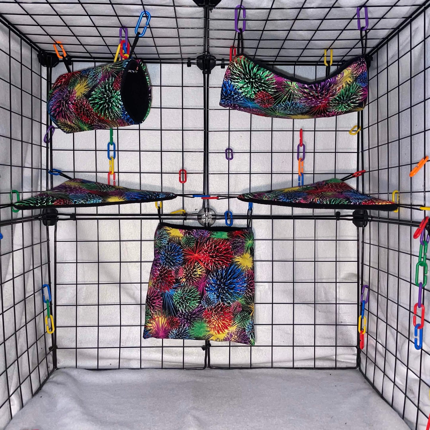 Firework print sugar glider expansion set with tunnel, hammock, shelves, and fleece accessories. Handmade cage add-ons for cozy glider play.