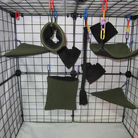 Forest green and black sugar glider cage set with fleece pouch, corner shelves, hammock, braided rope, and hanging toys installed in a wire cage.