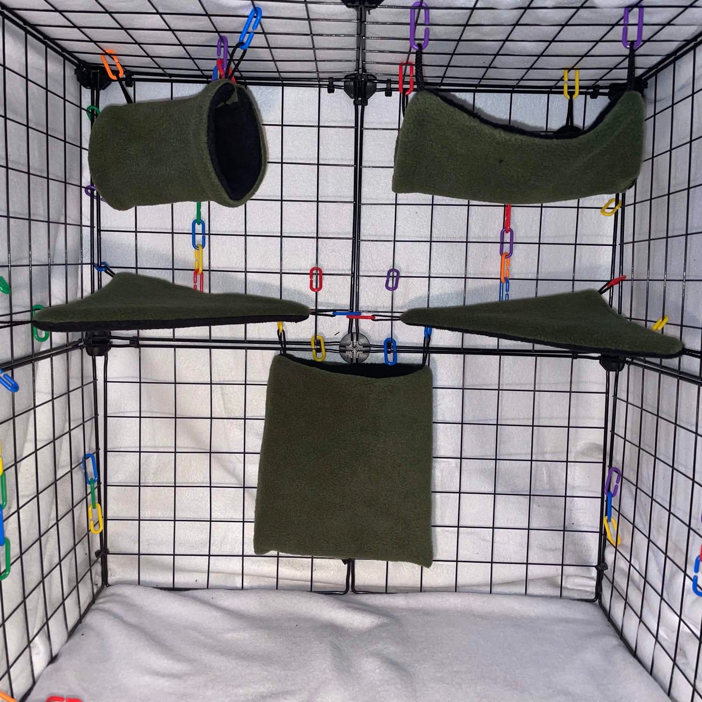 Forest green sugar glider cage set with black interior, hammocks, tunnel, pouch, and corner shelves shown in a display cage.