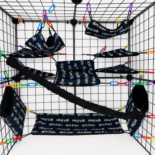 Harry Pot print sugar glider cage set with black lined fleece pouches, hammocks, shelves, bridge, and braided rope inside a display cage.