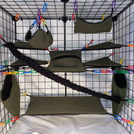 Sugar cage setup with hanging green Hammocks and a rope bridge on a grid display. 