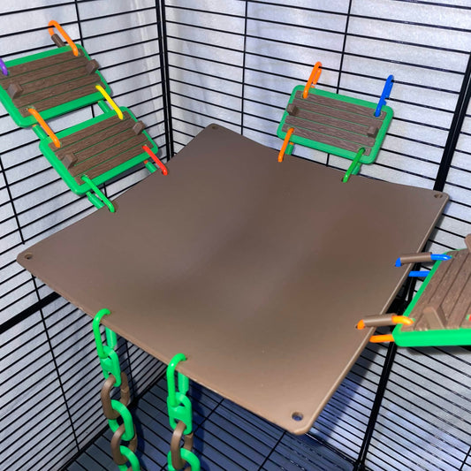 Brown hanging cage hammock viewed from above, with bridges and climbing chains attached.