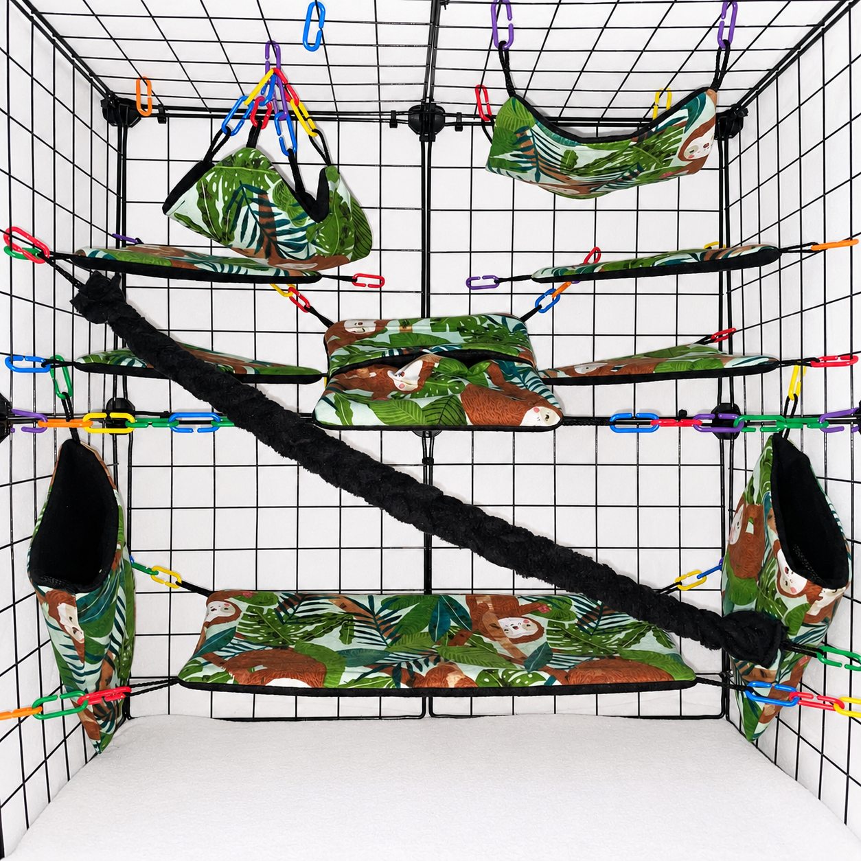 Tropical sloth print sugar glider cage set in a display cage with hammocks, pouches, bridge, black fleece vine, and black interior fleece.
