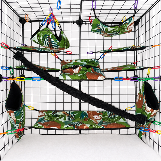 Tropical sloth print sugar glider cage set in a display cage with hammocks, pouches, bridge, black fleece vine, and black interior fleece.