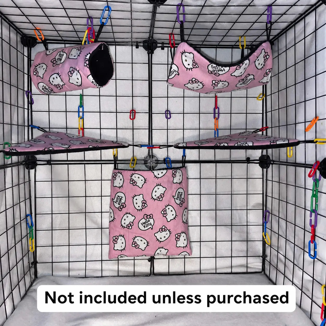 Pink kitty print sugar glider expansion set in a display cage with tunnel, hammock, corner shelves, and hanging pouch with black interior fleece.