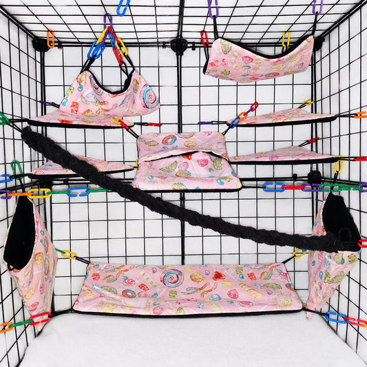 Pink candy print sugar glider cage set with hammocks, pouches, bridges, shelf liners, and black fleece vine.