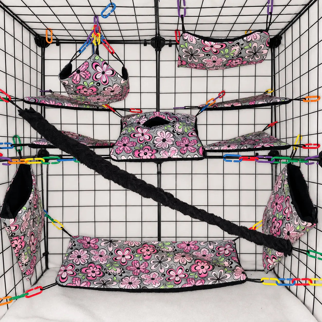 Pink floral print sugar glider cage set with hammocks, pouches, bridges, shelf liners, and fleece vine. Handmade cage accessories for pet gliders.