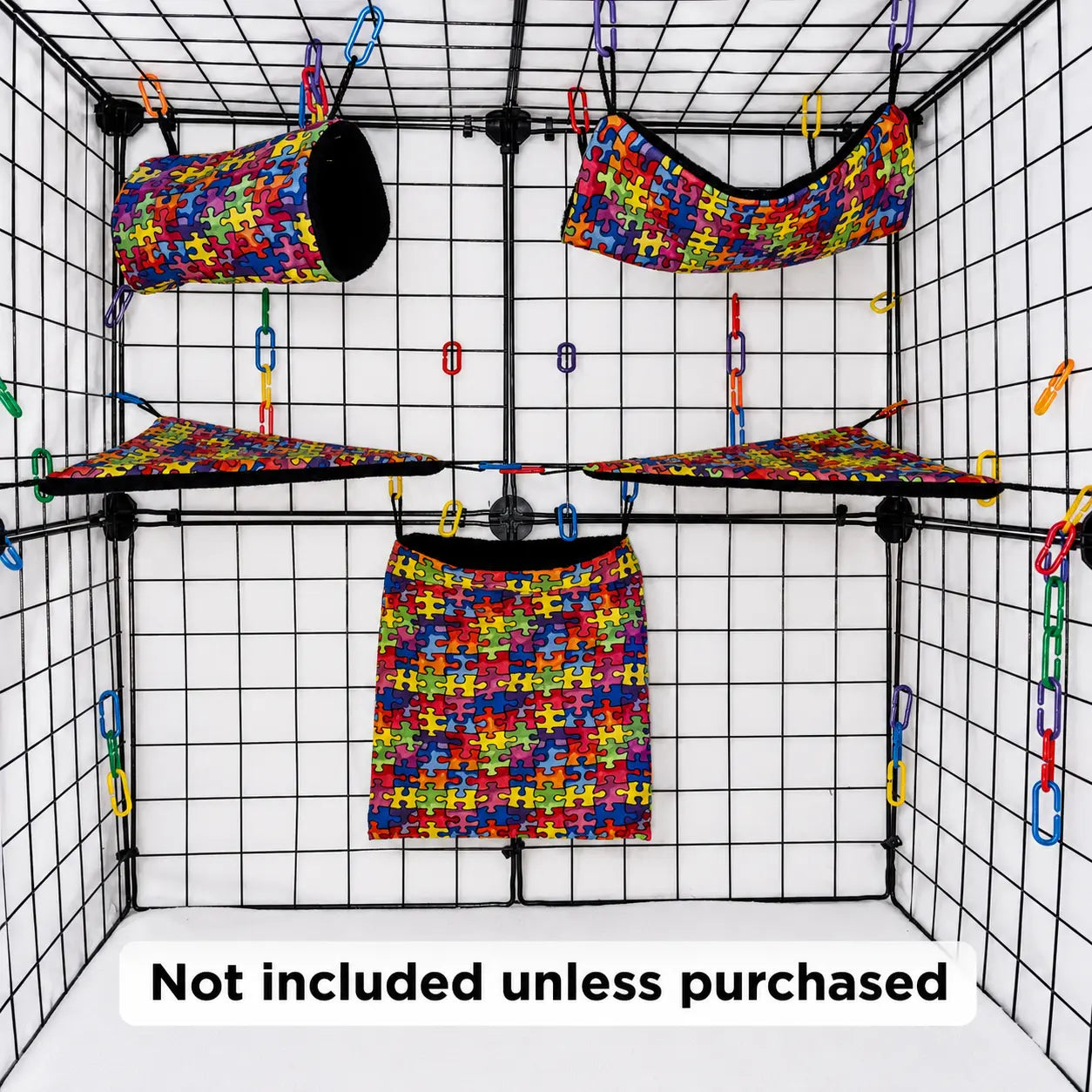 Colorful puzzle print sugar glider expansion cage set with black fleece interior of pouches, hammock, corner shelves, and colorful C-links inside a display cage.