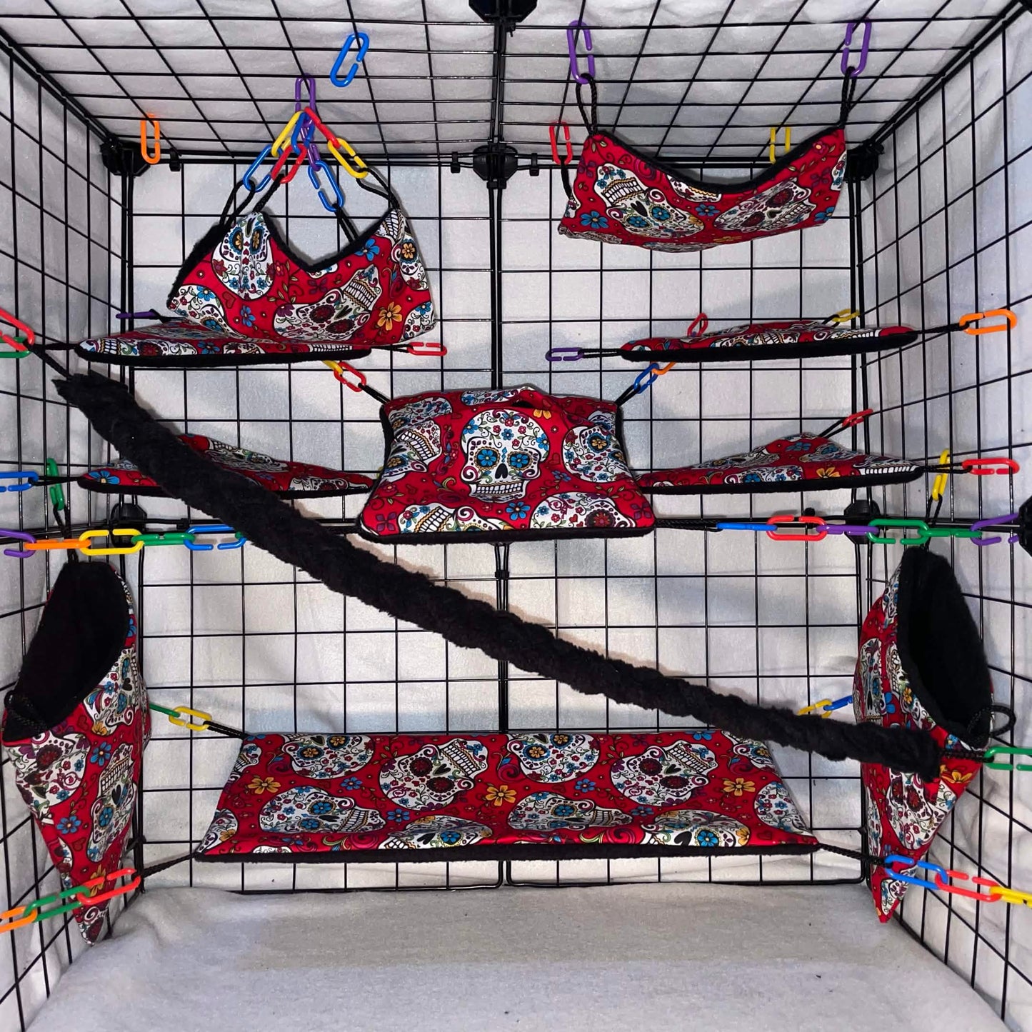 Red sugar skull sugar glider cage set with black fleece for interior of pouches, hammocks, shelves, bridge, and braided rope inside a display cage.