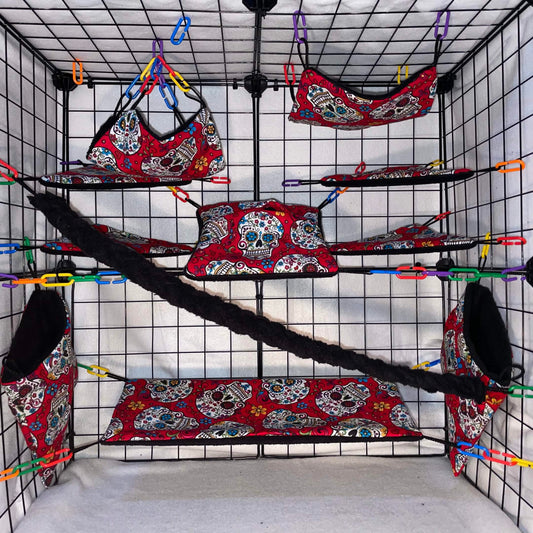 Red sugar skull sugar glider cage set with black fleece for interior of pouches, hammocks, shelves, bridge, and braided rope inside a display cage.