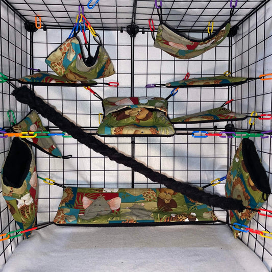 Safari animal print sugar glider cage set with black interior of pouches, hammocks, shelves, bridge, and braided rope inside a display cage.