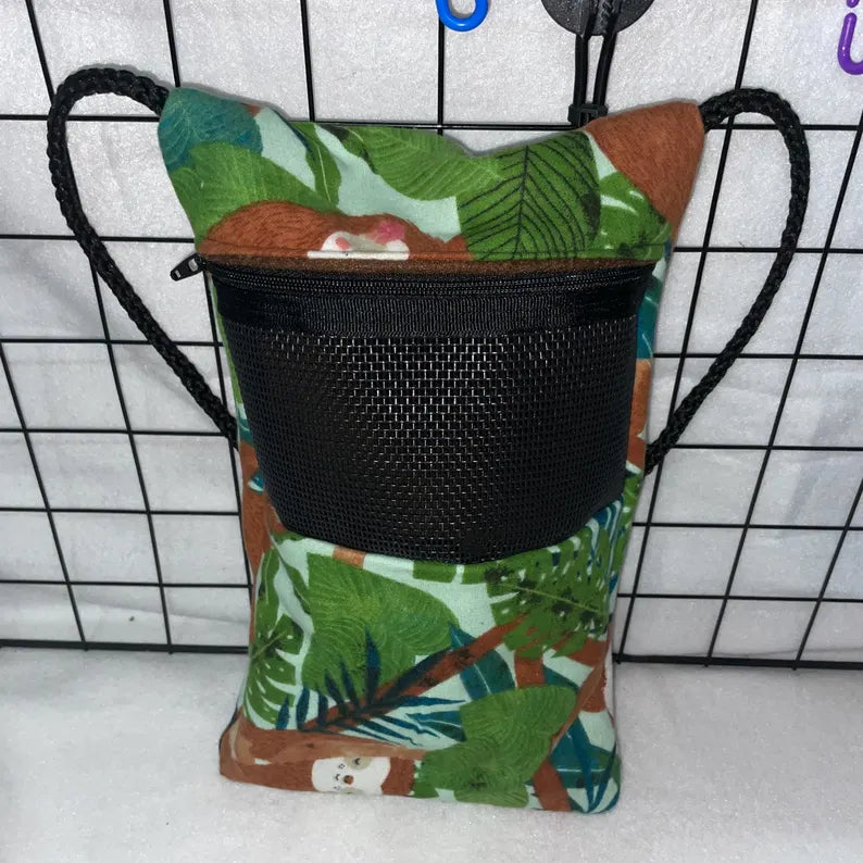 Sloth jungle print sugar glider bonding pouch with black mesh window, zipper, and shoulder strap hanging in a wire cage.