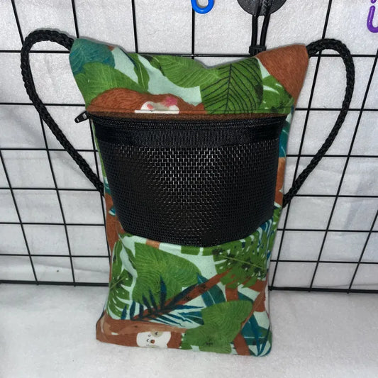 Sloth jungle print sugar glider bonding pouch with black mesh window, zipper, and shoulder strap hanging in a wire cage.