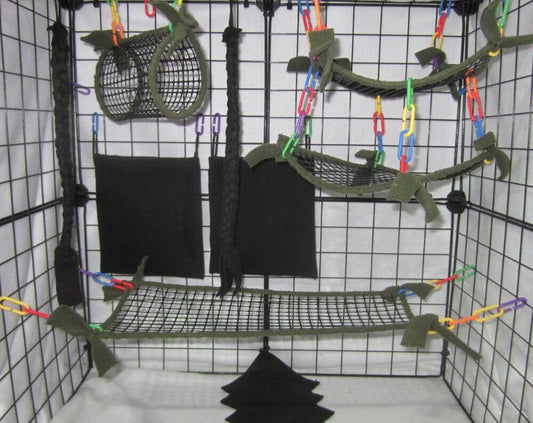 11-piece sugar glider cage set in forest green mesh, featuring breathable hammocks, tunnel, bridge, fleece pouches, braided ropes, and assorted C-links arranged inside a metal cage for small pet comfort and enrichment.